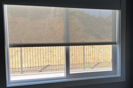 Newly installed custom roller shades for kitchen windows in Los Altos home, blending function with style and easy operation.